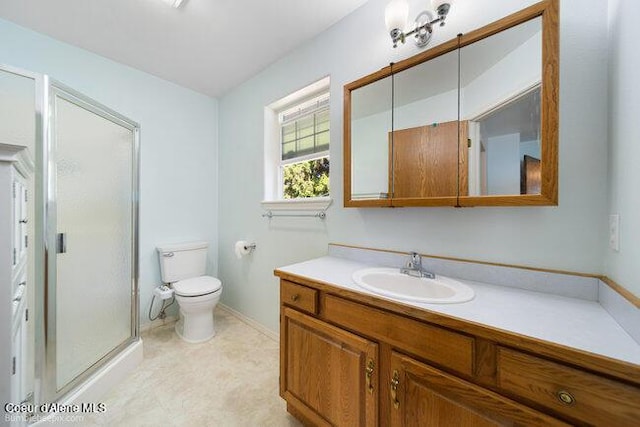 1547 E Stratford Dr, Hayden, ID 83835 - full bathroom featuring a stall shower, vanity, toilet, and baseboards