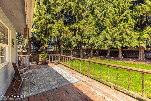 1547 E Stratford Dr, Hayden, ID 83835 - wooden terrace with a lawn and a fenced backyard