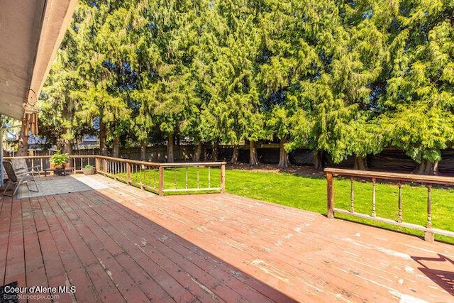 1547 E Stratford Dr, Hayden, ID 83835 - wooden terrace with a lawn and a fenced backyard
