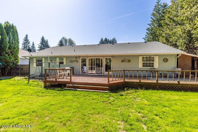 1547 E Stratford Dr, Hayden, ID 83835 - back of property with a yard, fence, and a deck