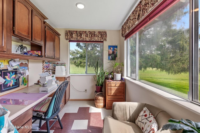 office area featuring light floors and baseboards