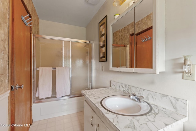 bathroom featuring vanity, shower / bath combination with glass door, and tile patterned floors