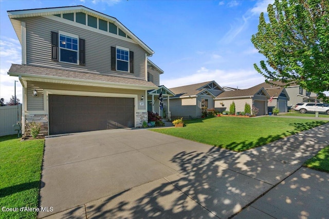 2097 W Calawah Ave, Post Falls, ID 83854 - view of front of home with an attached garage, a front yard, stone siding, and concrete driveway