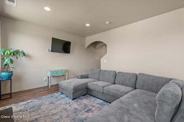 2097 W Calawah Ave, Post Falls, ID 83854 - living area with wood finished floors, recessed lighting, baseboards, a textured ceiling, and arched walkways