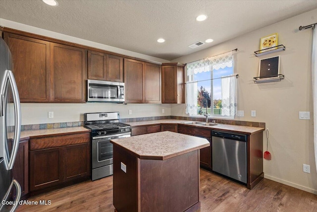 2097 W Calawah Ave, Post Falls, ID 83854 - kitchen featuring stainless steel appliances, a sink, light countertops, dark wood-style floors, and recessed lighting