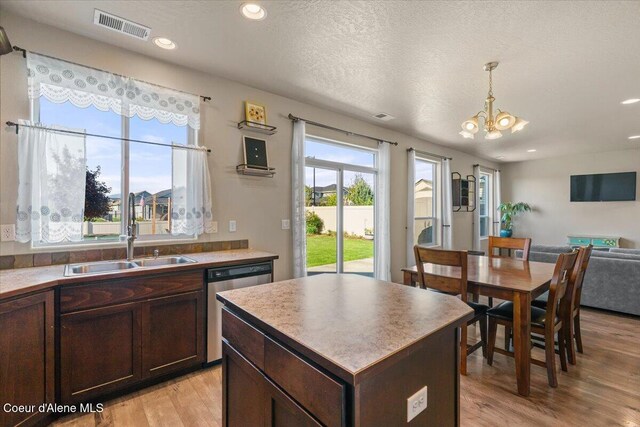 2097 W Calawah Ave, Post Falls, ID 83854 - kitchen featuring a sink, dishwasher, light wood-type flooring, a chandelier, and dark brown cabinetry
