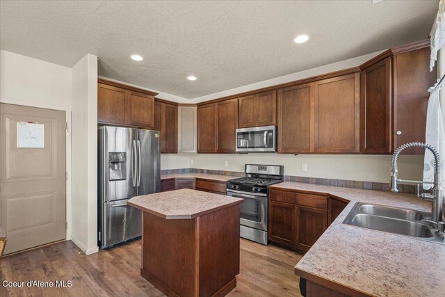2097 W Calawah Ave, Post Falls, ID 83854 - kitchen featuring stainless steel appliances, a sink, a center island, light countertops, and recessed lighting