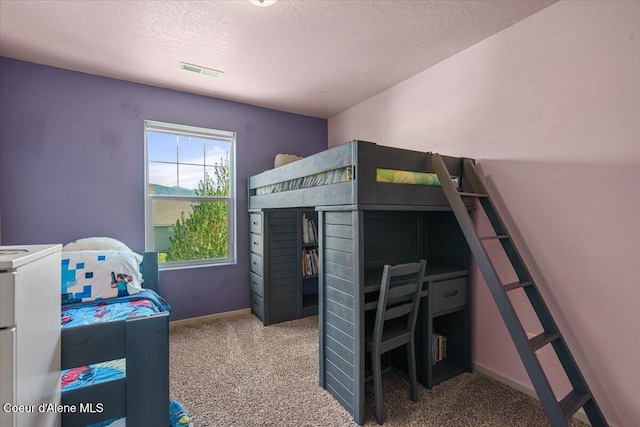 2097 W Calawah Ave, Post Falls, ID 83854 - carpeted bedroom featuring a textured ceiling and baseboards