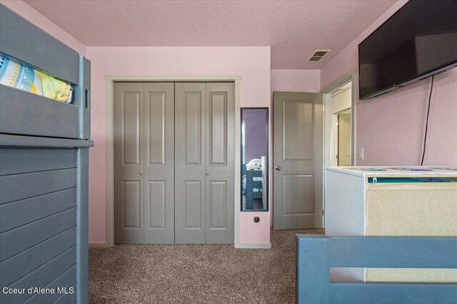 2097 W Calawah Ave, Post Falls, ID 83854 - unfurnished bedroom featuring a closet, carpet, and a textured ceiling
