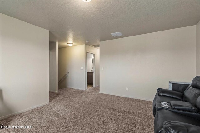 2097 W Calawah Ave, Post Falls, ID 83854 - living area with light carpet, a textured ceiling, and baseboards