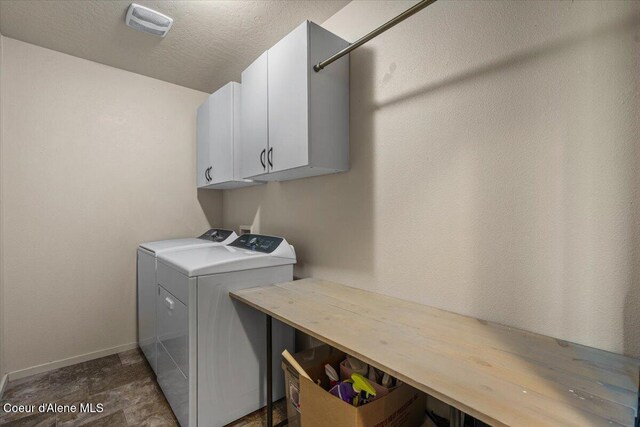 2097 W Calawah Ave, Post Falls, ID 83854 - laundry room featuring cabinet space, baseboards, and washer and clothes dryer