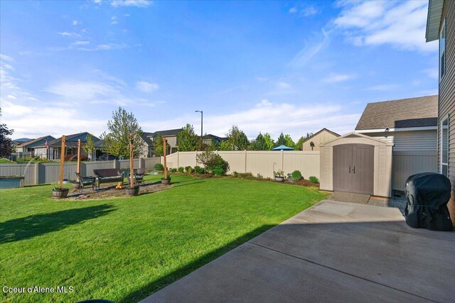 2097 W Calawah Ave, Post Falls, ID 83854 - view of yard featuring a patio, a shed, an outdoor structure, and a residential view