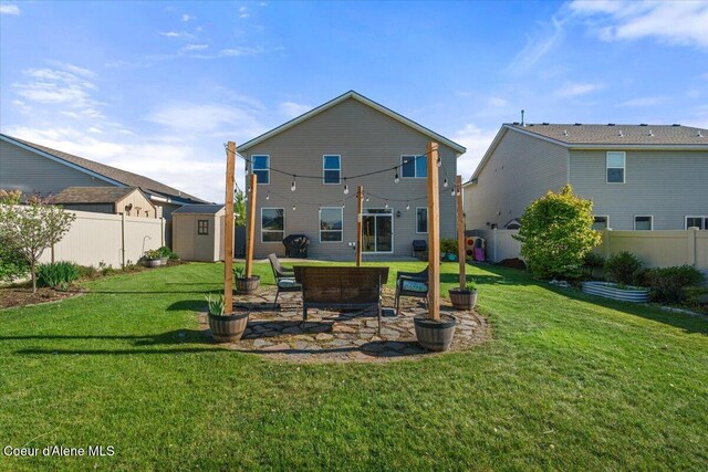 2097 W Calawah Ave, Post Falls, ID 83854 - back of property featuring a storage shed, an outbuilding, and a patio area