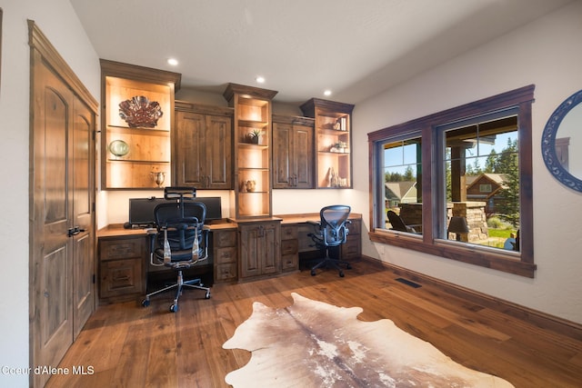11671 N Spiraea Ln, Hayden, ID 83835 - office space with built in desk, dark wood finished floors, baseboards, and recessed lighting
