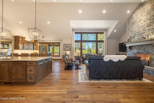 11671 N Spiraea Ln, Hayden, ID 83835 - living area featuring a chandelier, high vaulted ceiling, wood finished floors, recessed lighting, and a fireplace