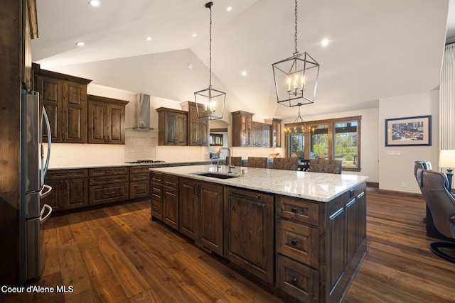 11671 N Spiraea Ln, Hayden, ID 83835 - kitchen featuring a sink, stainless steel appliances, a spacious island, wall chimney range hood, and dark wood-type flooring