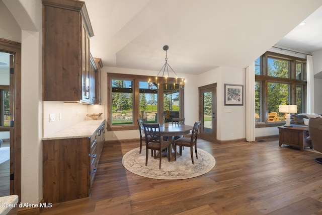 11671 N Spiraea Ln, Hayden, ID 83835 - dining room with baseboards, dark wood-style flooring, and a chandelier