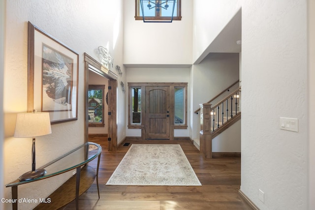 11671 N Spiraea Ln, Hayden, ID 83835 - entryway featuring a textured wall, wood finished floors, baseboards, a high ceiling, and stairs