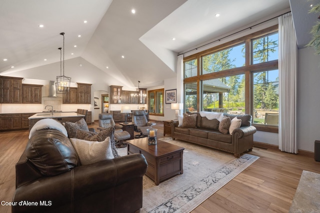11671 N Spiraea Ln, Hayden, ID 83835 - living room featuring high vaulted ceiling, light wood-style floors, recessed lighting, and a chandelier