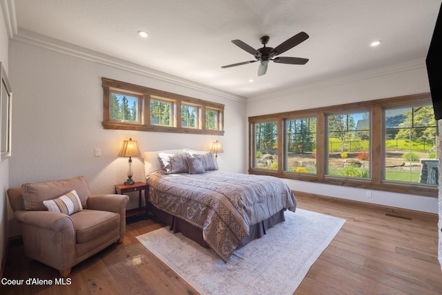 11671 N Spiraea Ln, Hayden, ID 83835 - bedroom featuring wood finished floors, crown molding, recessed lighting, a ceiling fan, and baseboards