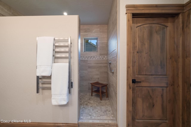 11671 N Spiraea Ln, Hayden, ID 83835 - bathroom featuring a stall shower, a towel warmer, and radiator heating unit