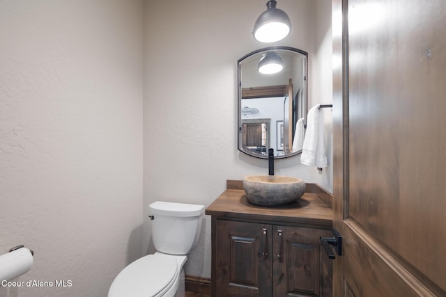 11671 N Spiraea Ln, Hayden, ID 83835 - bathroom with toilet, vanity, and a textured wall