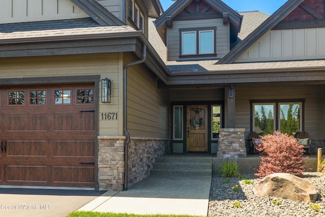 11671 N Spiraea Ln, Hayden, ID 83835 - entrance to property featuring stone siding, roof with shingles, board and batten siding, and covered porch