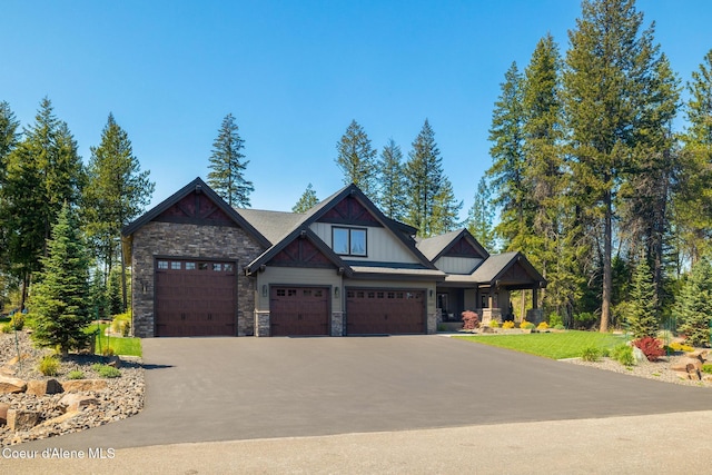 11671 N Spiraea Ln, Hayden, ID 83835 - craftsman-style house featuring stone siding, driveway, an attached garage, and board and batten siding