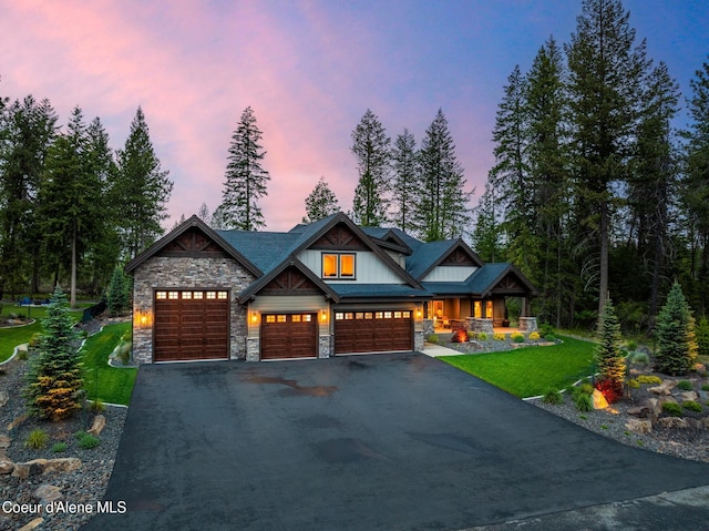 11671 N Spiraea Ln, Hayden, ID 83835 - craftsman-style home featuring stone siding, covered porch, asphalt driveway, a front yard, and an attached garage