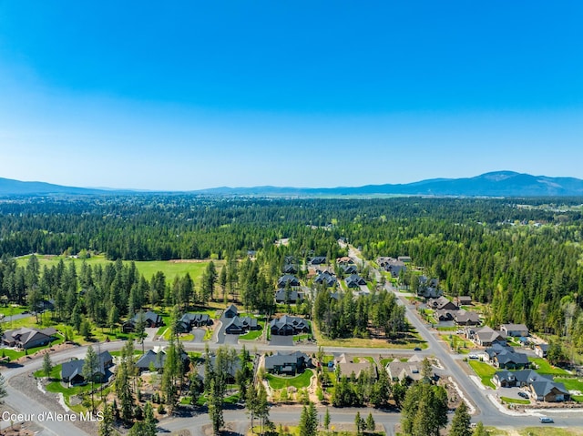 11671 N Spiraea Ln, Hayden, ID 83835 - aerial view of property's location with a heavily wooded area, a mountain backdrop, and nearby suburban area