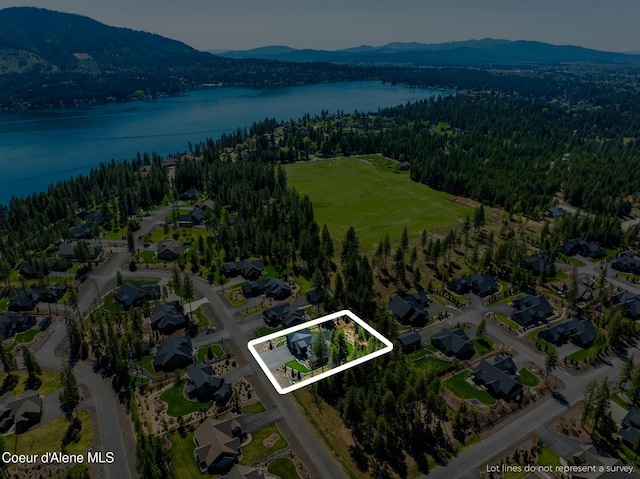 11671 N Spiraea Ln, Hayden, ID 83835 - aerial overview of property's location featuring a water and mountain view, a heavily wooded area, and nearby suburban area