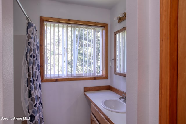 31582 E Hayden Lake Rd, Hayden, ID 83835 - bathroom with a shower with curtain, a wealth of natural light, and vanity