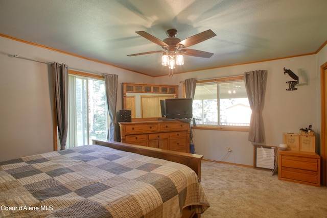 31582 E Hayden Lake Rd, Hayden, ID 83835 - bedroom featuring multiple windows, light carpet, a ceiling fan, and ornamental molding