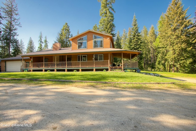 31582 E Hayden Lake Rd, Hayden, ID 83835 - view of front of home with a front yard, metal roof, a chimney, and a garage