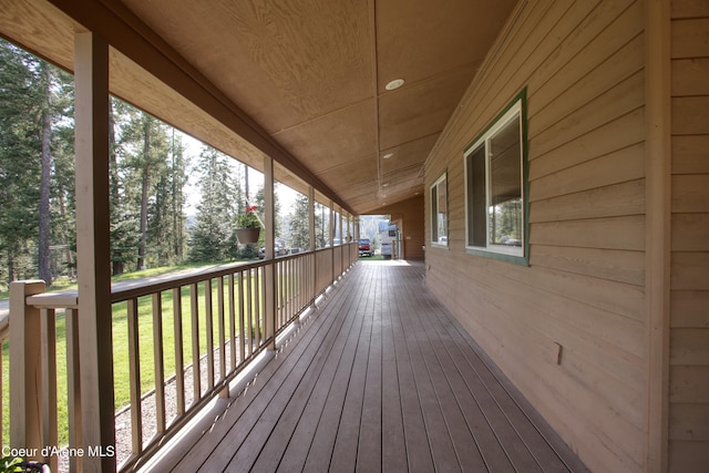 31582 E Hayden Lake Rd, Hayden, ID 83835 - wooden deck with covered porch and a lawn