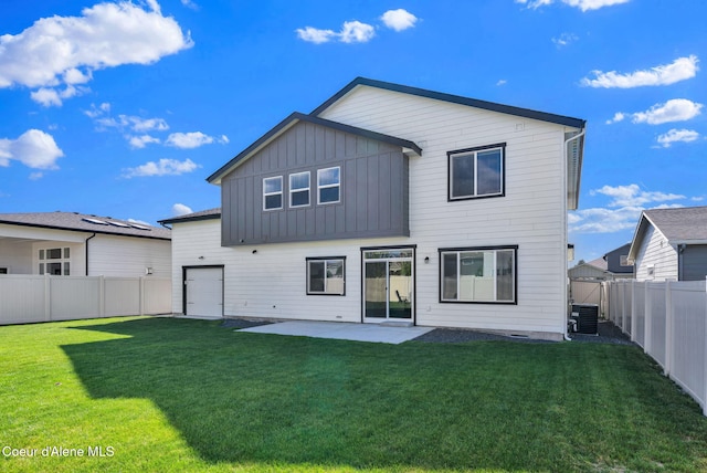 2878 N Callary St, Post Falls, ID 83854 - back of property with central air condition unit, board and batten siding, a patio, and a lawn