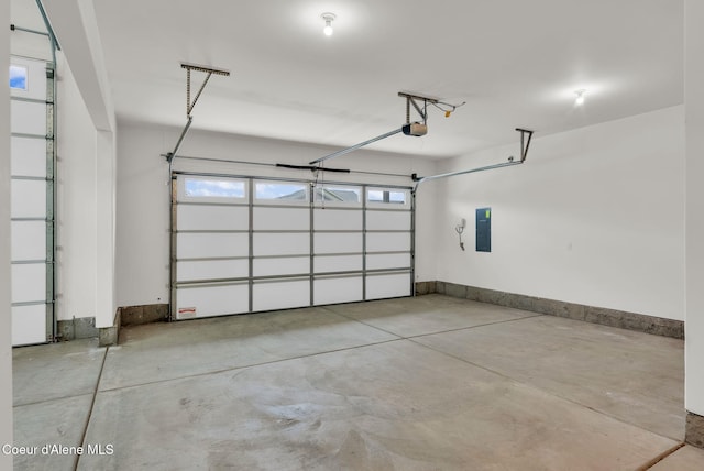 2878 N Callary St, Post Falls, ID 83854 - garage featuring baseboards, electric panel, and a garage door opener