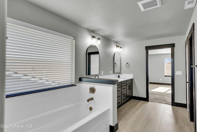 2878 N Callary St, Post Falls, ID 83854 - full bathroom with a sink, double vanity, a garden tub, and visible vents