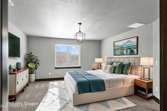 2878 N Callary St, Post Falls, ID 83854 - bedroom featuring a chandelier, a textured ceiling, light carpet, and baseboards