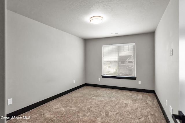 2878 N Callary St, Post Falls, ID 83854 - empty room with baseboards, a textured ceiling, visible vents, and carpet