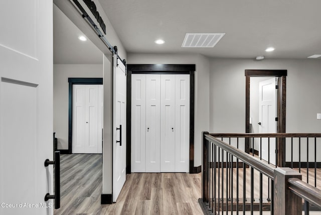 2878 N Callary St, Post Falls, ID 83854 - hallway featuring an upstairs landing, light wood-type flooring, visible vents, a barn door, and recessed lighting