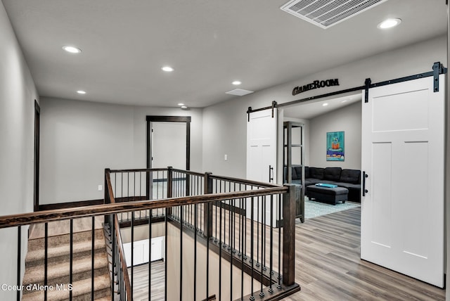 2878 N Callary St, Post Falls, ID 83854 - corridor with recessed lighting, visible vents, a barn door, and wood finished floors