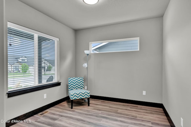 2878 N Callary St, Post Falls, ID 83854 - living area featuring baseboards, visible vents, and wood finished floors