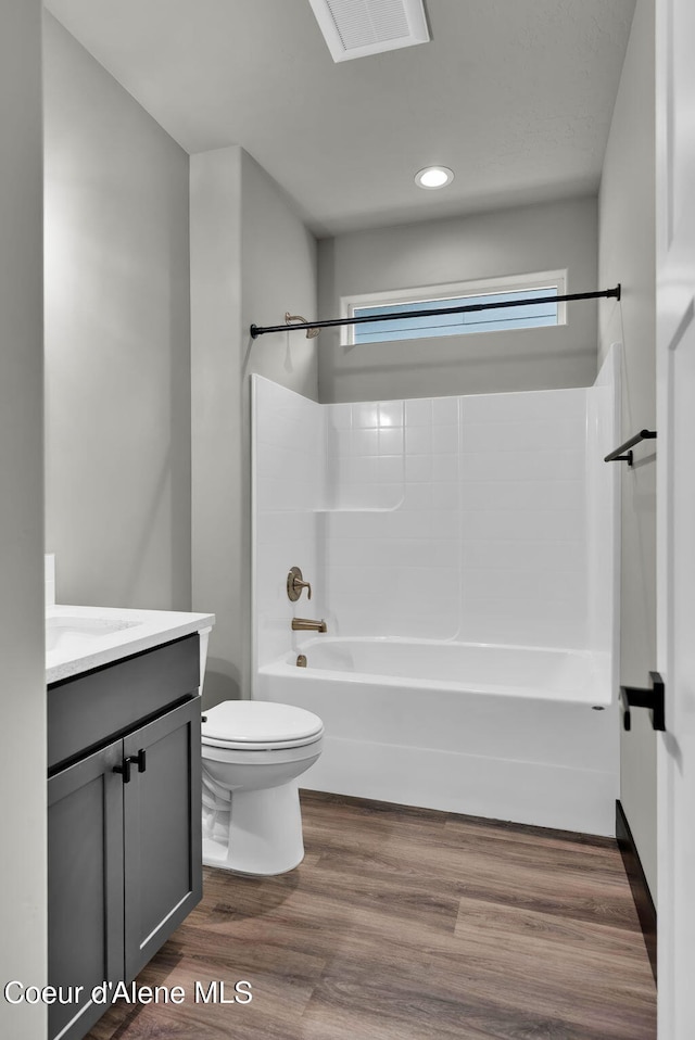 2878 N Callary St, Post Falls, ID 83854 - bathroom with toilet, wood finished floors, vanity, recessed lighting, and shower / bath combination