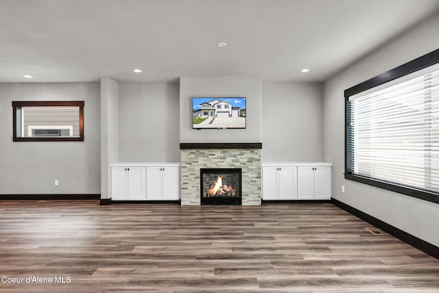 2878 N Callary St, Post Falls, ID 83854 - unfurnished living room featuring baseboards, recessed lighting, and wood finished floors