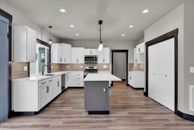 2878 N Callary St, Post Falls, ID 83854 - kitchen featuring recessed lighting, a sink, decorative backsplash, a kitchen island, and appliances with stainless steel finishes