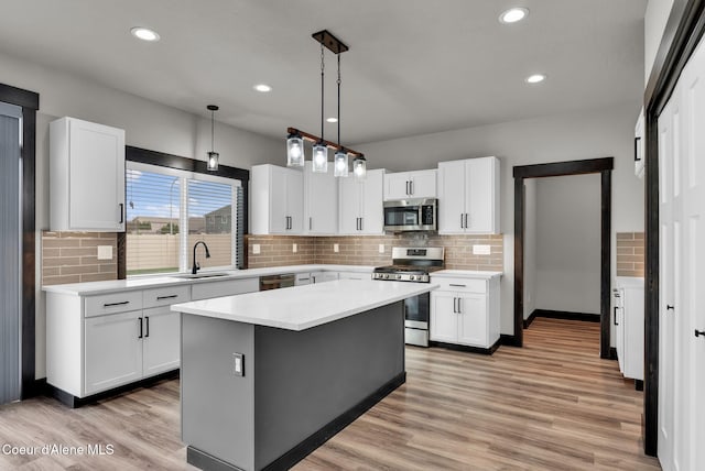 2878 N Callary St, Post Falls, ID 83854 - kitchen featuring light countertops, white cabinetry, stainless steel appliances, and a sink