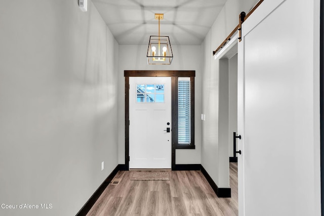 2878 N Callary St, Post Falls, ID 83854 - entryway with light wood-type flooring, baseboards, and a barn door