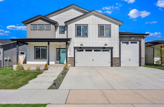 2878 N Callary St, Post Falls, ID 83854 - modern farmhouse featuring covered porch, an attached garage, stone siding, board and batten siding, and driveway
