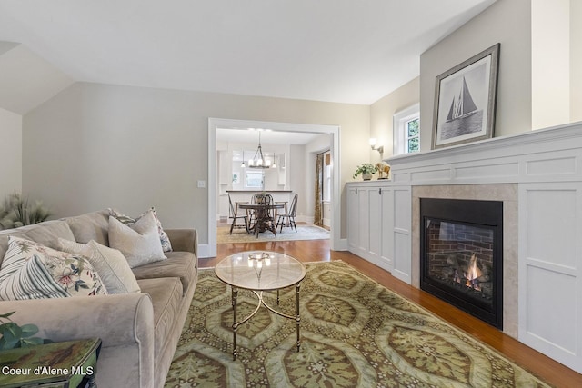 306 S Huron Ave, Sandpoint, ID 83864 - living room featuring an inviting chandelier, plenty of natural light, and wood finished floors